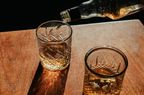 Whisky is poured into two glasses