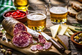 Beer with Spanish tapas on a table.