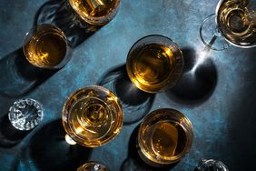 Drinks in glasses on a dark marbled blue background. 