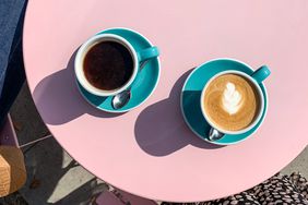 Morning coffees on a pink table. 