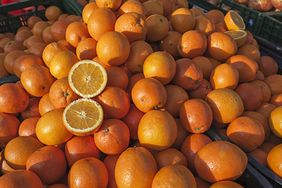 A pile of oranges in sunlight.