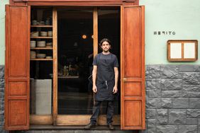 Chef Juan Luis Martinez standing at the door of Merito Restaurant in Lima