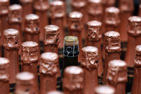 Bottles of sparkling wine with pink foil.