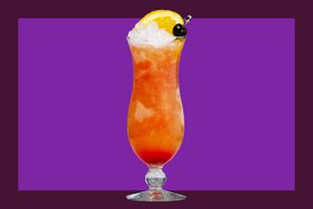 A hurricane cocktail on a purple background