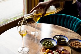 Bottle of dessert white wine pouring into glass