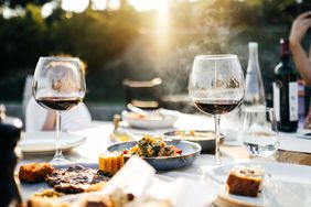 Grilling, wine and steak outdoors.