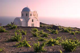 Chapel and vineyard above Mesa Pigadia Bay. Near Akrotiri, Santorini, Cyclades Islands, Greece